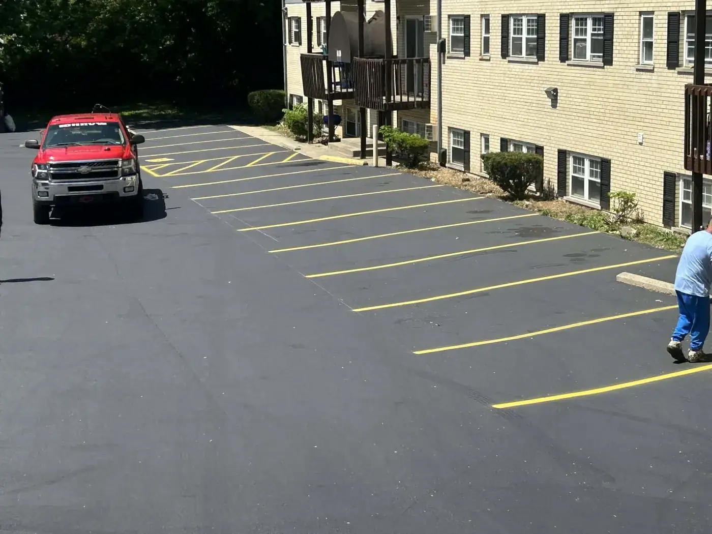 Freshly paved and striped commercial parking lot by C.P.R. Concrete & Blacktop